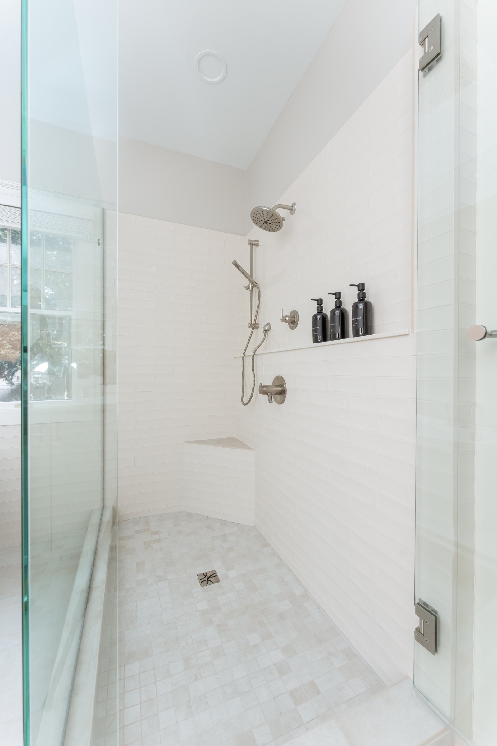 Spa Sanctuary bathroom — double vanity with white shaker cabinetry and quartz countertops