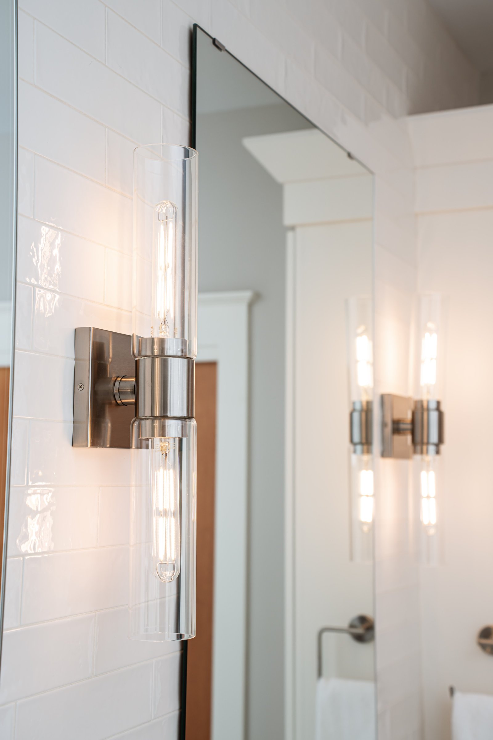 Spa Sanctuary bathroom — modern sconces and vanity mirror
