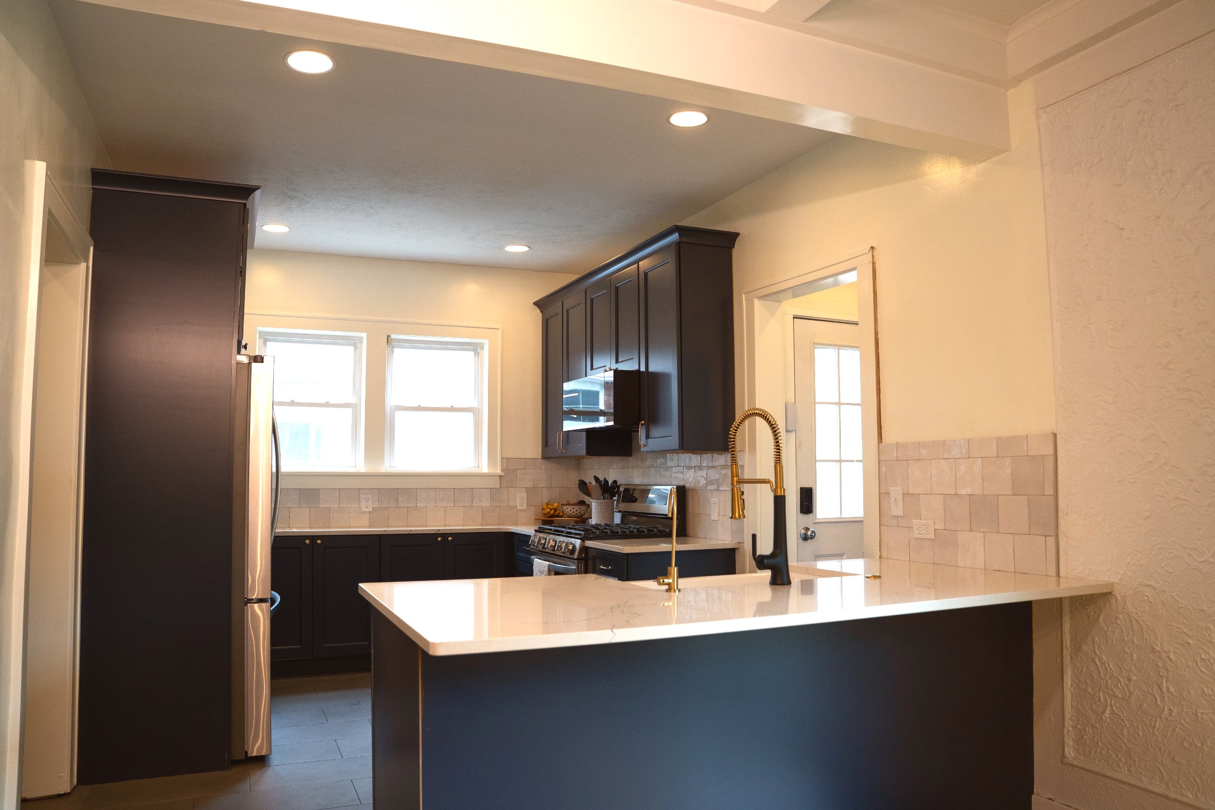 Navy & Gold bathroom — navy vanity with gold fixtures and white tile