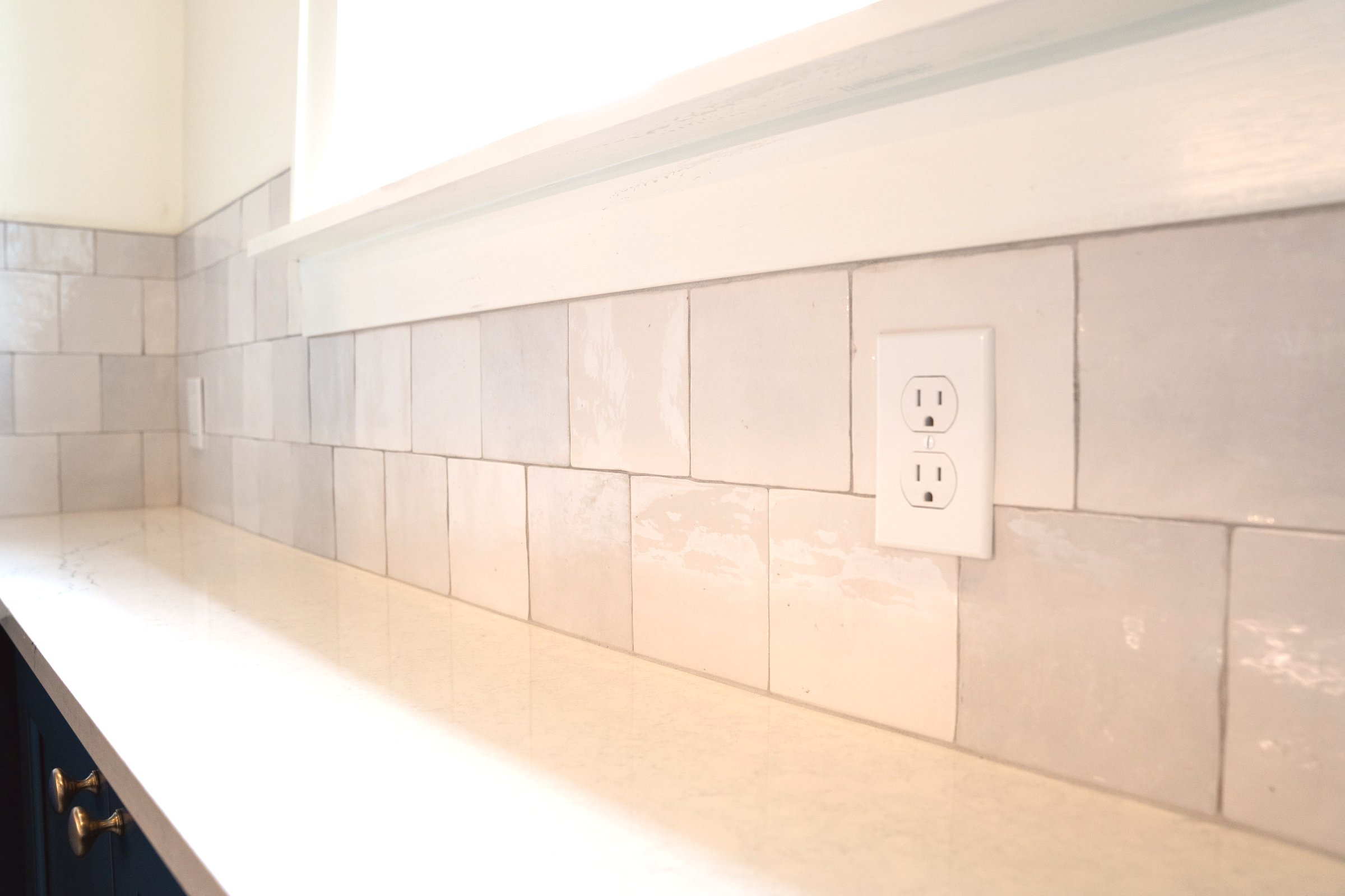 Navy & Gold kitchen — farmhouse sink with gold brass faucet and navy cabinetry