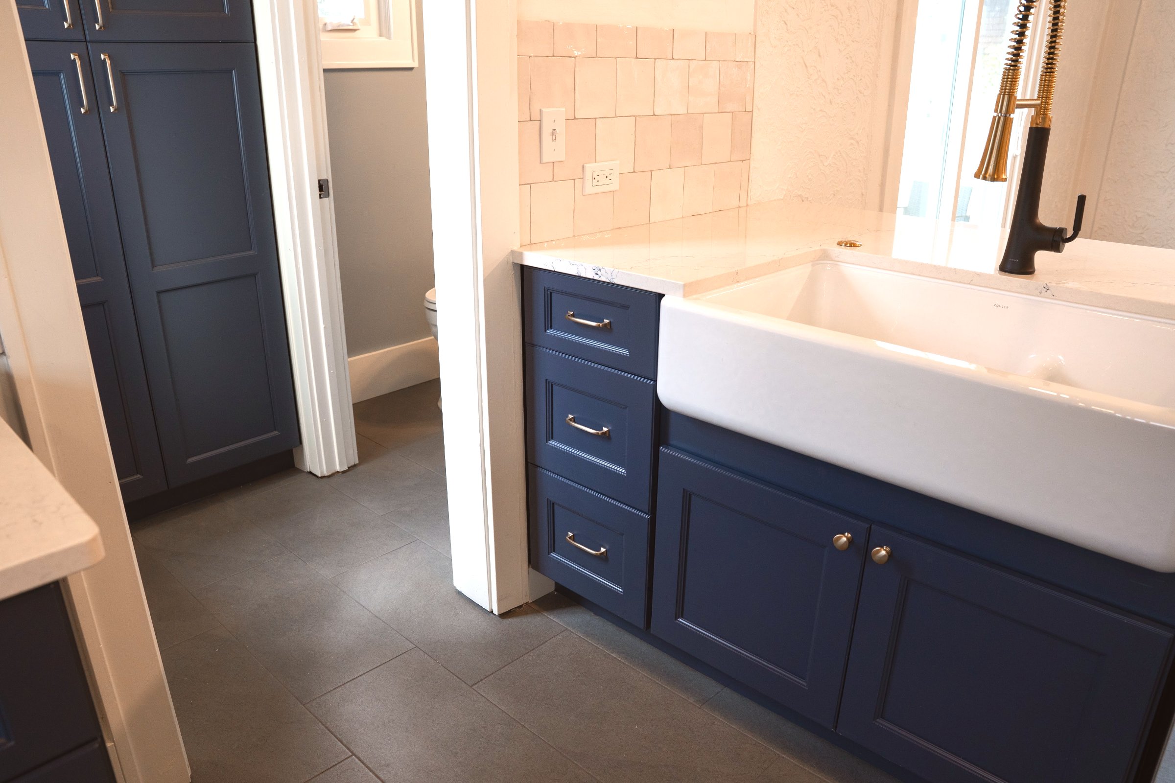 Navy & Gold kitchen — subway tile backsplash and stainless steel appliances