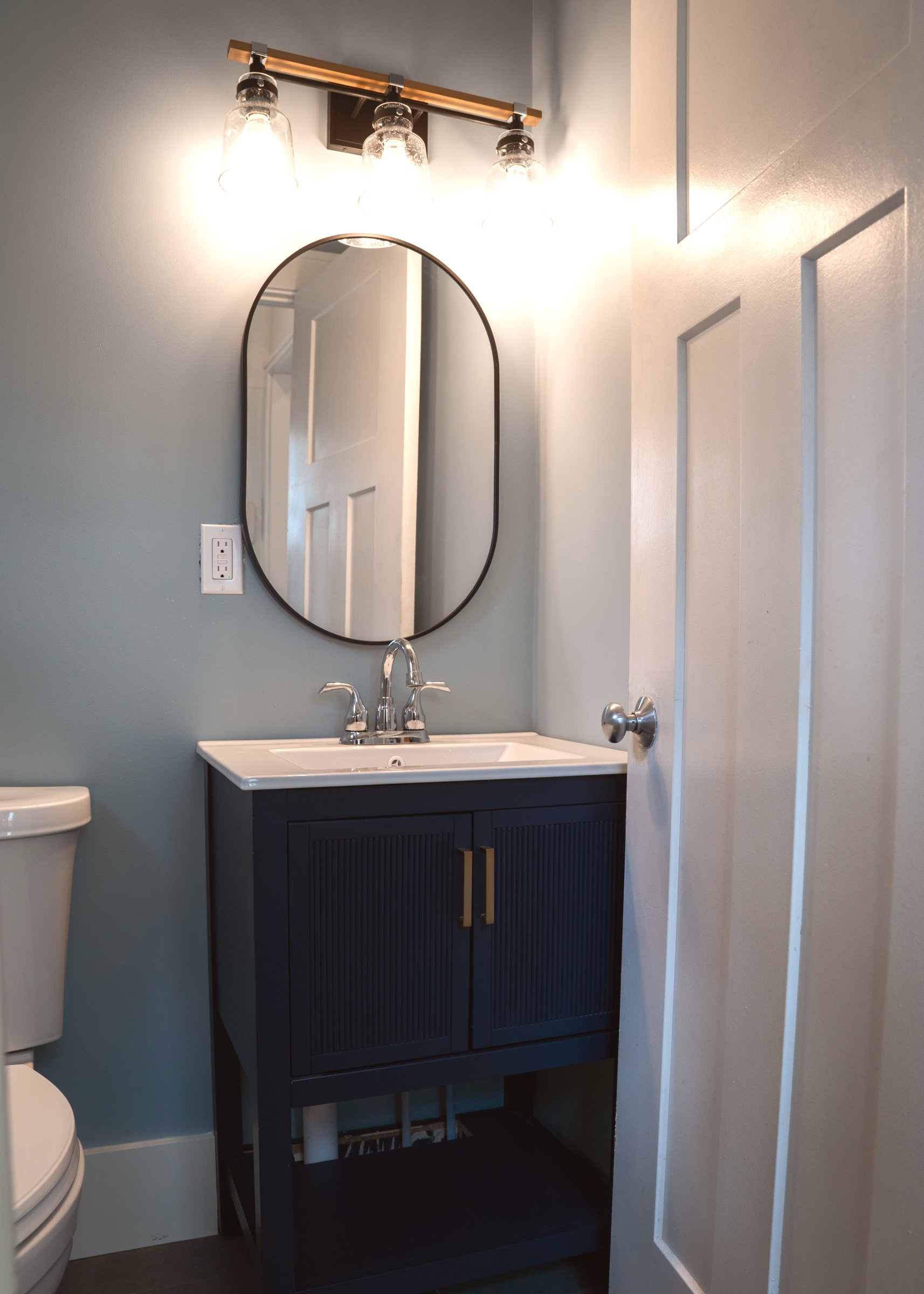 Navy & Gold kitchen — pendant lighting over white quartz countertop island