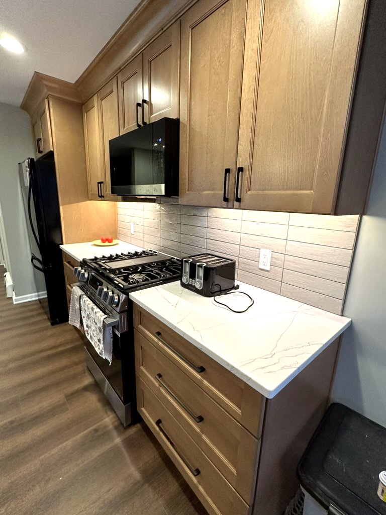 Hallway update — dark trim, crown molding, and hardwood floors leading to master suite