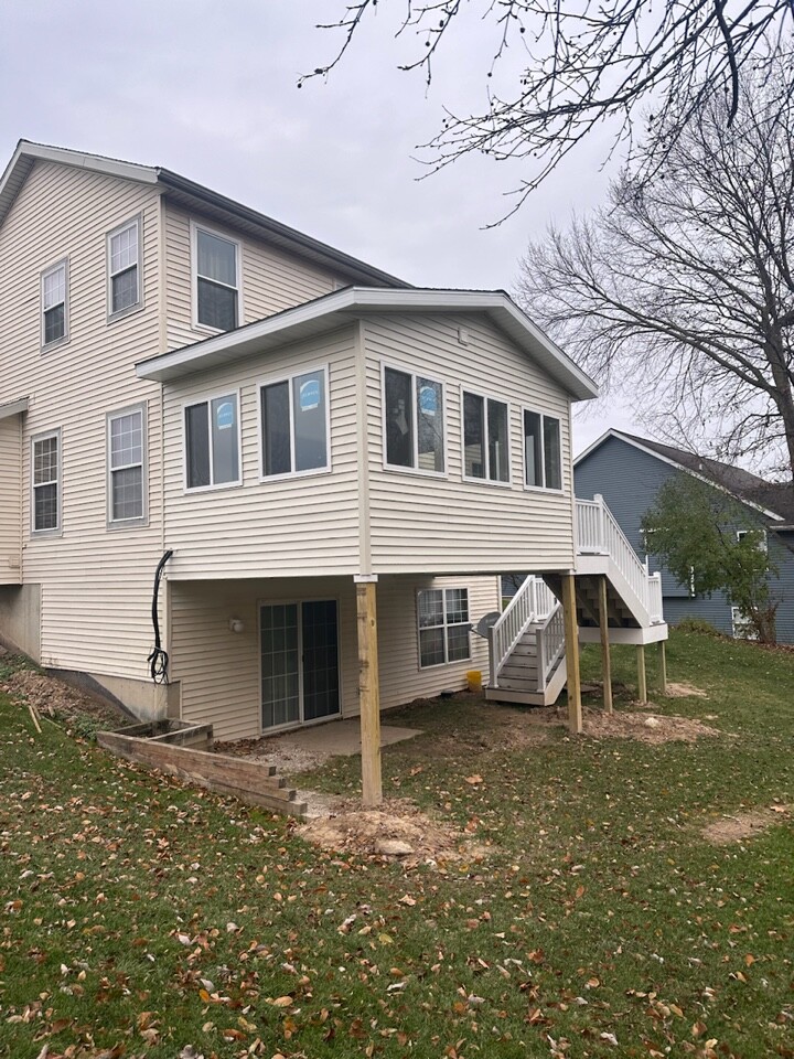 Rear Footprint Expansion — kitchen and family-room rear addition with exterior trim matched to the original home, built by Thornapple Construction