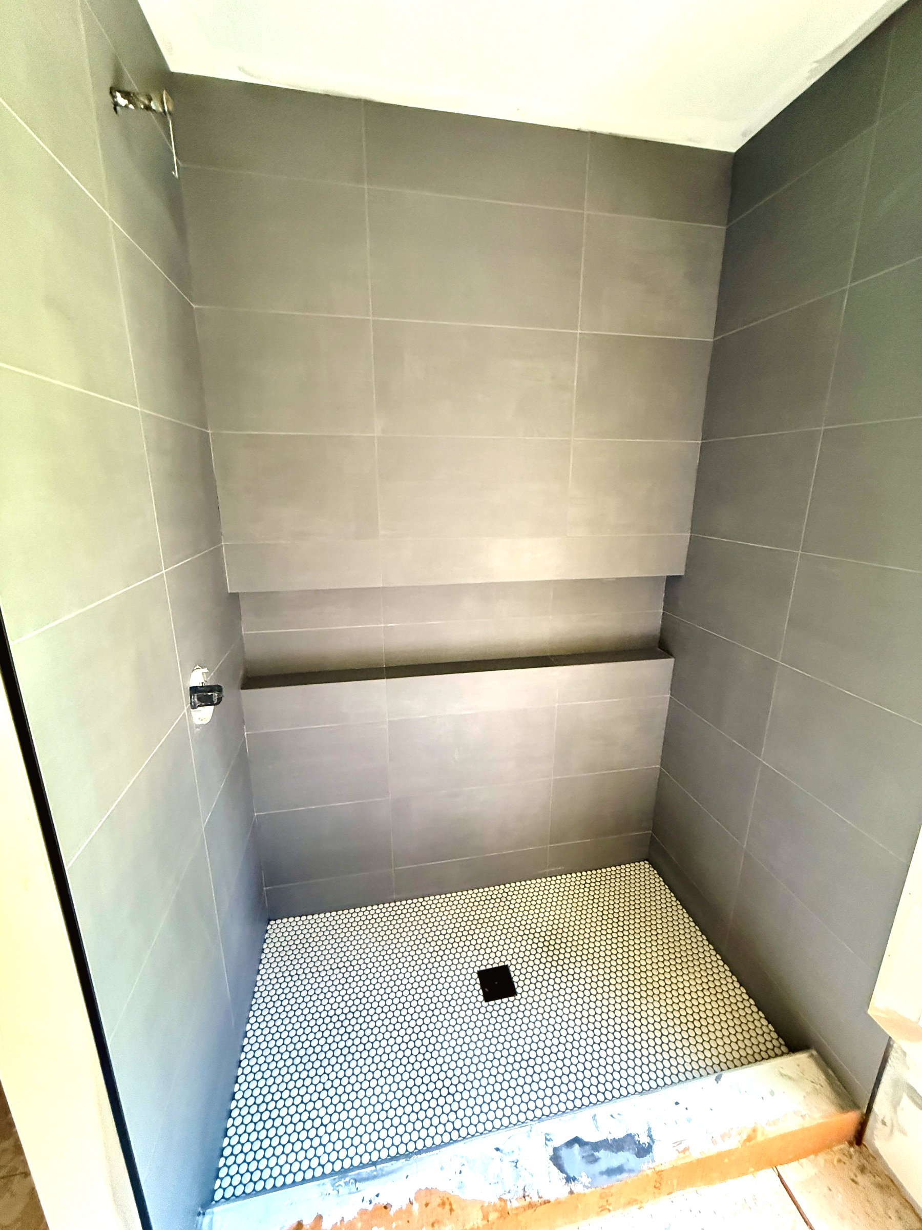 Finished tile work — clean grout lines and balanced pattern across full wall